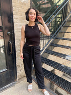 Step into effortless style with the Alice Black Crepe High Waist Pants. Designed for both comfort and chicness, these pants feature a flattering straight leg and a stylish self-tie belt, perfect for showcasing your fashion sense. 

- High waist with a self-tie belt for a customised fit 
- Textured knit crepe for added style 
- Convenient pockets for practicality 
- Relaxed straight fit for all-day comfort 
- Elastic back waistband for ease of movement 

