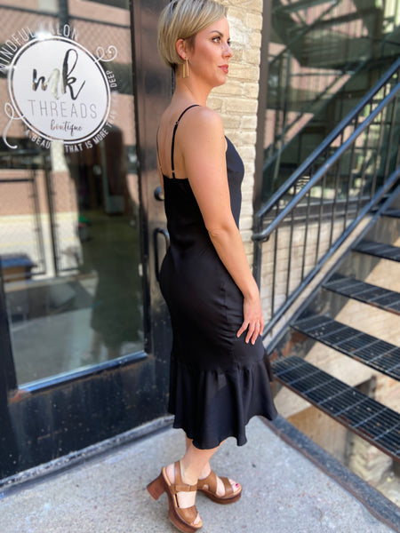 Step out in style with the Briella Black Ruffle Trim Midi Dress. This elegant black dress perfectly combines sophistication with charm. Its ruffle trims add a playful twist, making it ideal for both casual outings and special occasions. 

- Flattering midi length 
- Chic ruffle detailing 
- Versatile for various events 
- Made from high-quality materials 