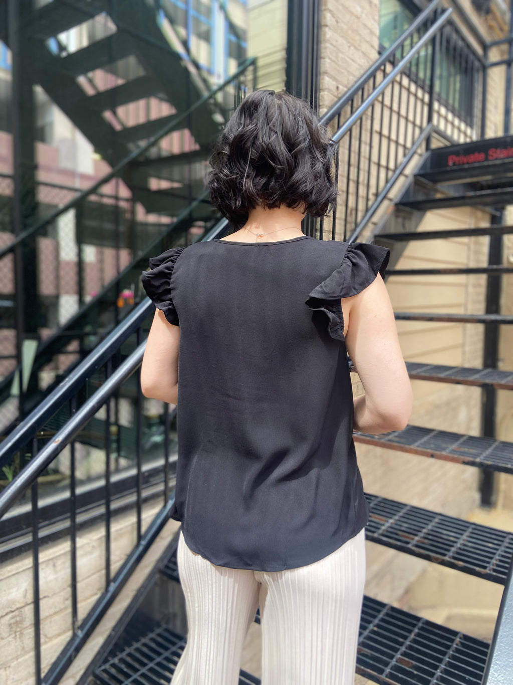Elevate your wardrobe with the Bodhi Black Flutter Sleeve Blouse. This chic piece features a split neck and delicate ruffle sleeves, making it a perfect addition for any occasion. Effortlessly versatile, you can dress it up for a night out or keep it casual for brunch with friends. 

- Split neck design for a modern twist 
- Flutter sleeves with ruffle detail for added elegance 
- Versatile style—dress it up or down with ease 
- Ideal for both casual and dressy events 