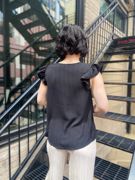 Elevate your wardrobe with the Bodhi Black Flutter Sleeve Blouse. This chic piece features a split neck and delicate ruffle sleeves, making it a perfect addition for any occasion. Effortlessly versatile, you can dress it up for a night out or keep it casual for brunch with friends. 

- Split neck design for a modern twist 
- Flutter sleeves with ruffle detail for added elegance 
- Versatile style—dress it up or down with ease 
- Ideal for both casual and dressy events 