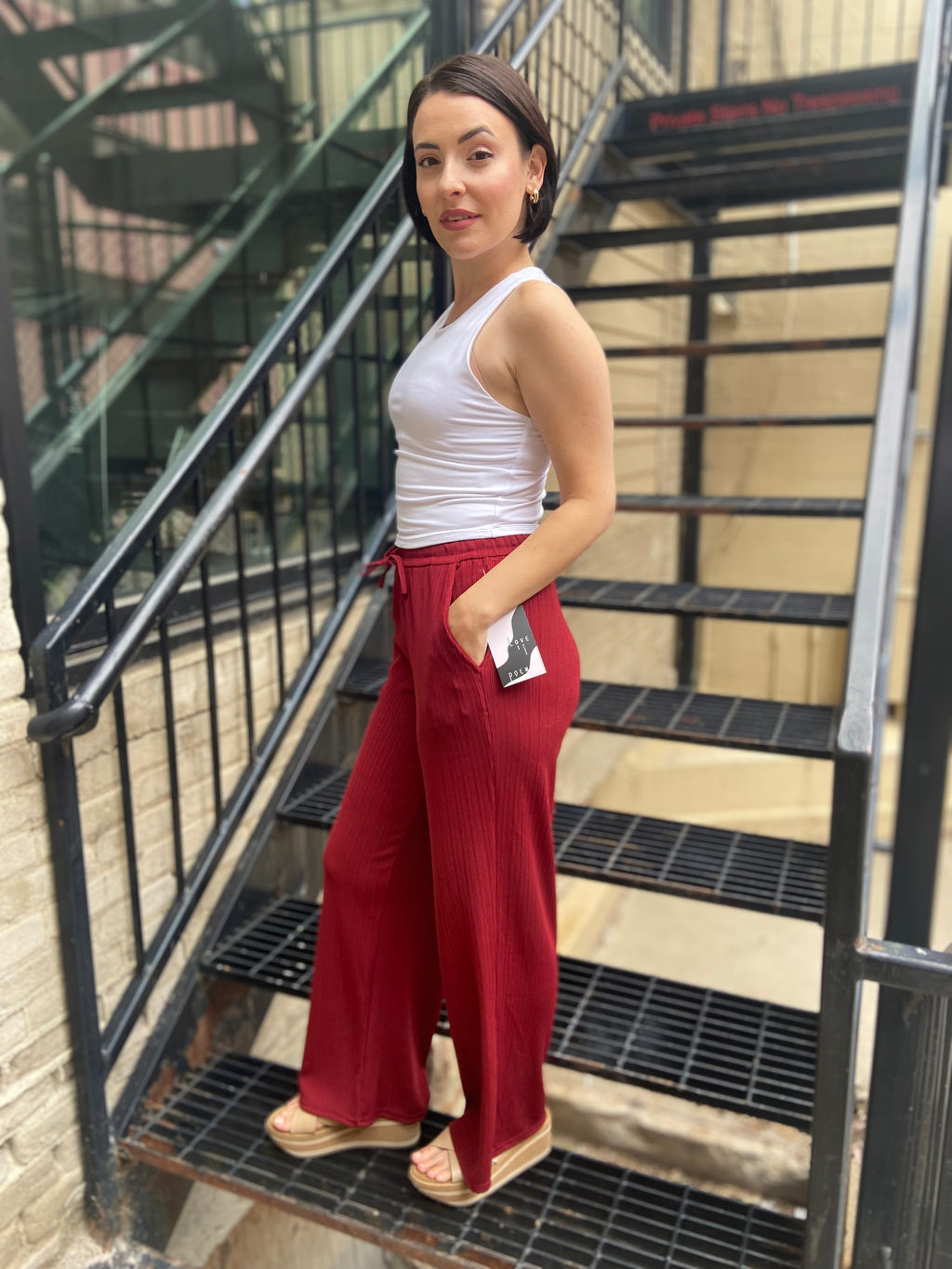 Step into style and comfort with the Jodie Red Ribbed Drawstring Pants. These pants are effortlessly chic and perfect for any occasion. With an elastic waist for a custom fit and a flattering wide-leg silhouette, you’ll feel fabulous every time you wear them. Plus, the convenient pockets ensure your essentials are always within reach.

- Elastic waist for ultimate comfort
- Flattering wide-leg design
- Handy pockets for your essentials
- Soft ribbed fabric for a luxurious feel
- Care: Hand wash cold and lin