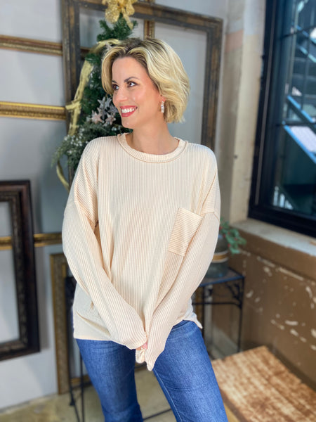 Cream colored corded sweatshirt with front chest pocket from Zenana paired with blue jeans