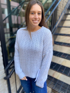 Round neck light blue gray sweater knit paired with blue jeans