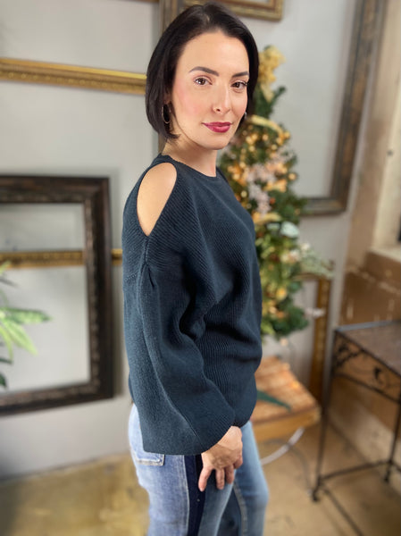 Side view of a dark green cold shoulder sweater