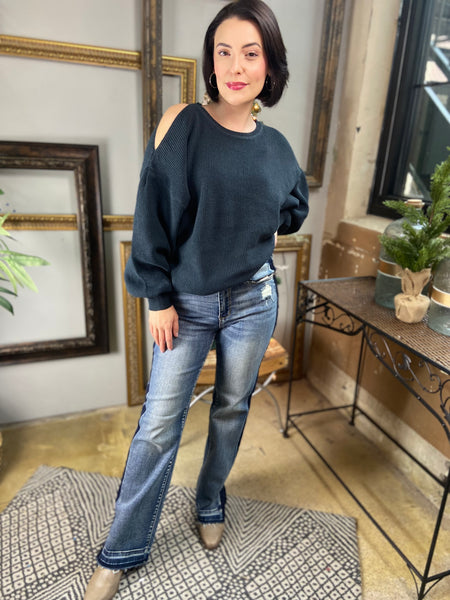 A dark green cold shoulder sweater paired with a pair of Judy Blue jeans