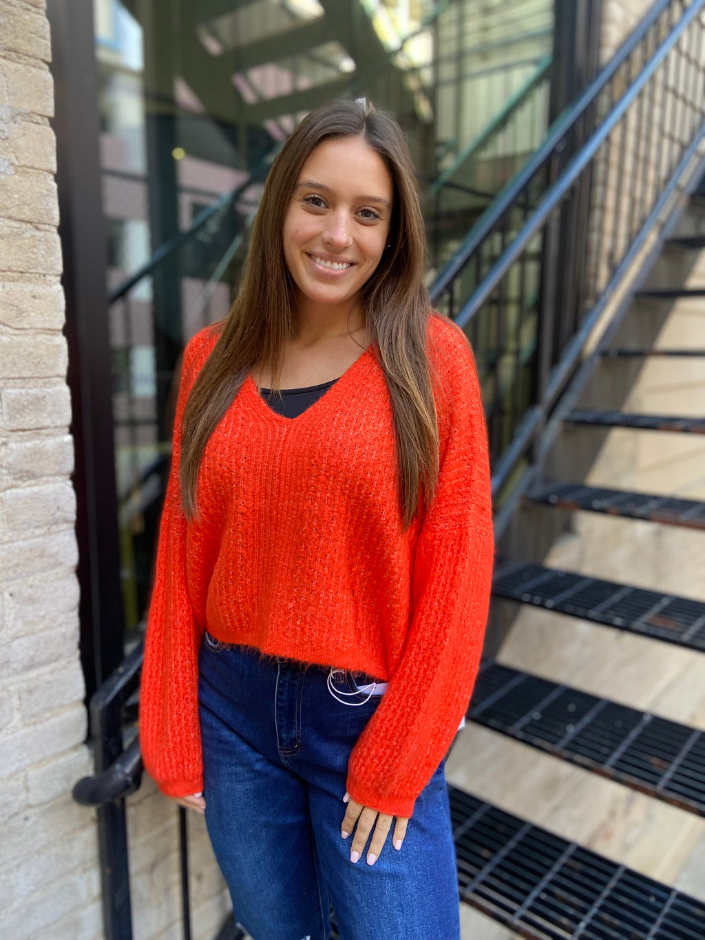 Waist length bright orange v neck sweater