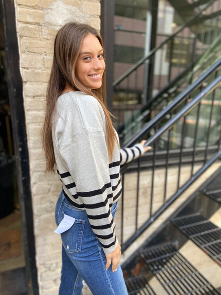 side view of heather gray and black striped sweater