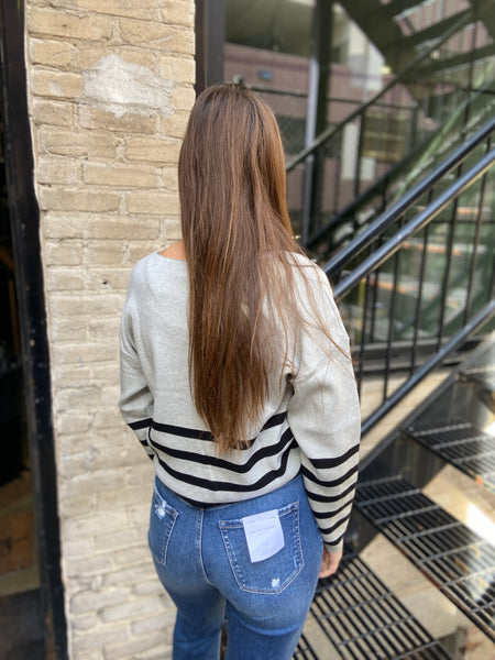 Back view of heather gray and black striped sweater