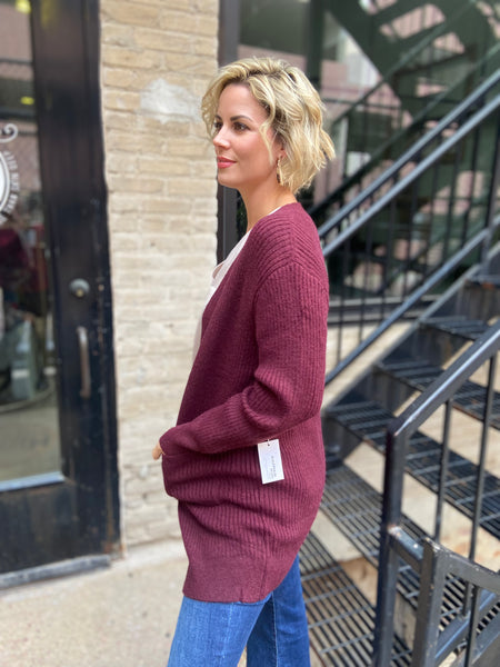 Side view of a Burgundy colored cardigan sweater