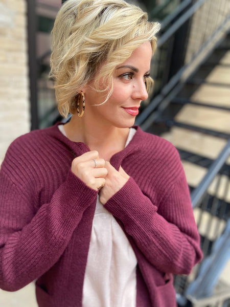 Up Close view of a Burgundy colored cardigan sweater