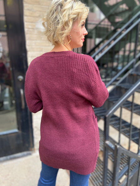 Back view of a Burgundy colored cardigan sweater