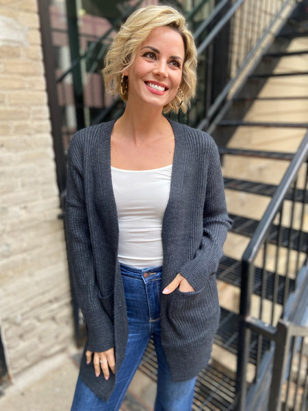 Charcoal cardigan sweater over a white tank with blue jeans