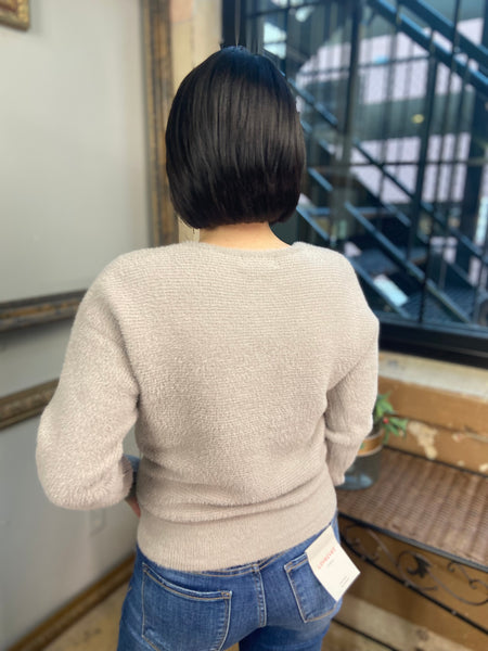 Back view of a soft, fuzzy  grey v neck sweater from Be Cool Brand