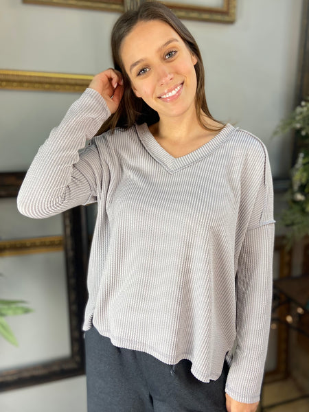 Silver colored V Neck long sleeved top with drop shoulders