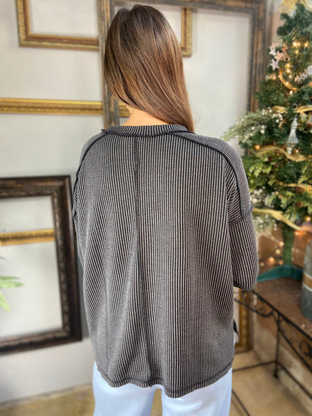 Back view of a Black Ribbed V Neck Long Sleeve Top with Drop Shoulders.