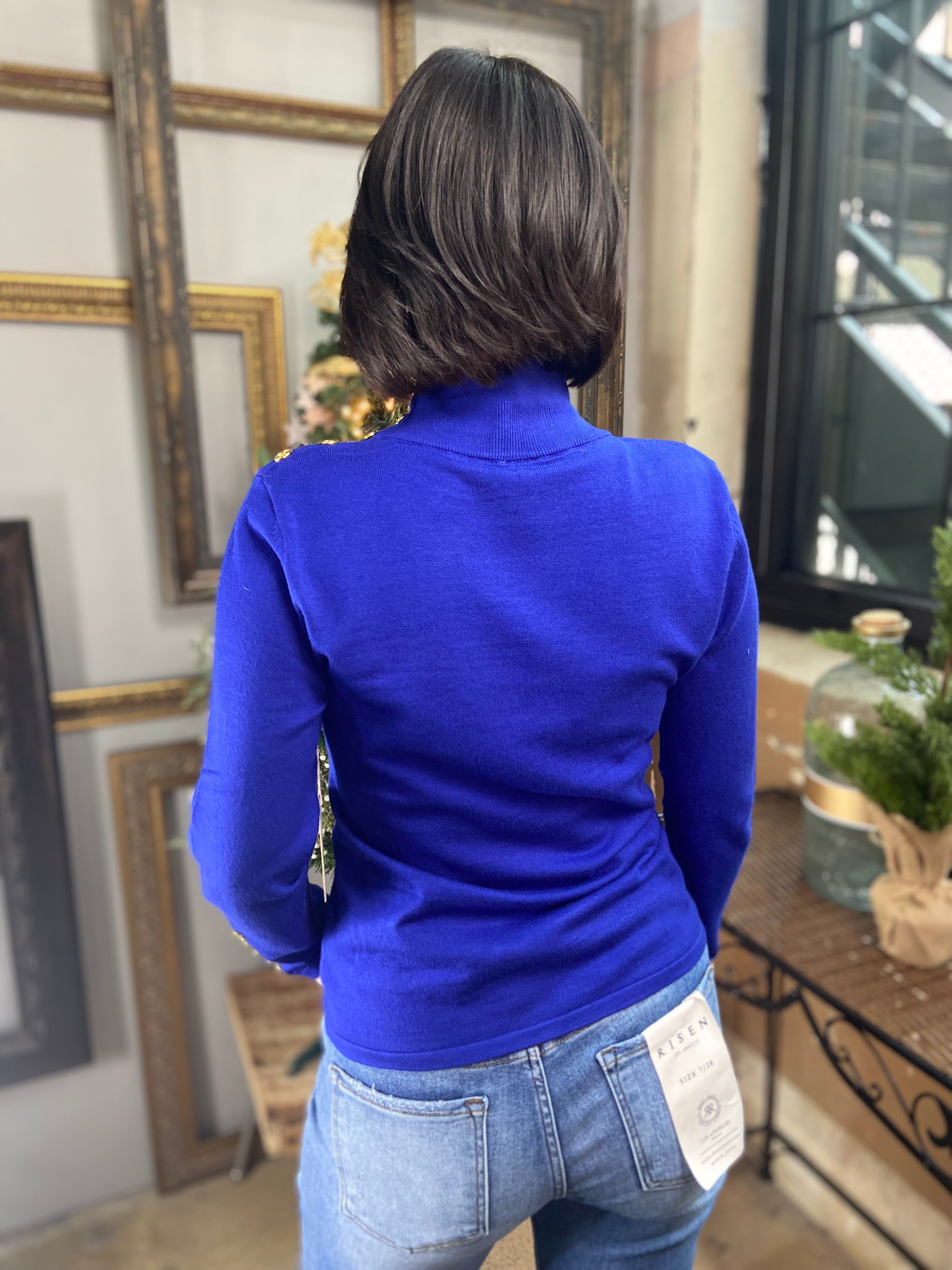Back view of royal blue mock neck sweater