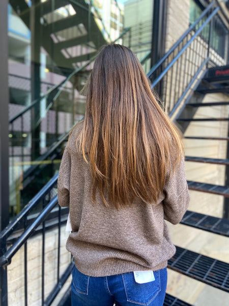 back view of mocha colored sweater paired with blue jeans