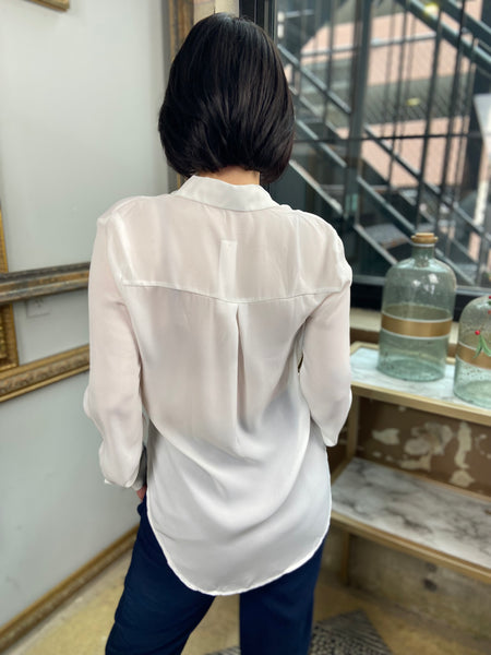 Back view of a white chiffon long sleeve blouse