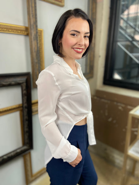 side view of a white Chiffon button down blouse with long sleeves and collar