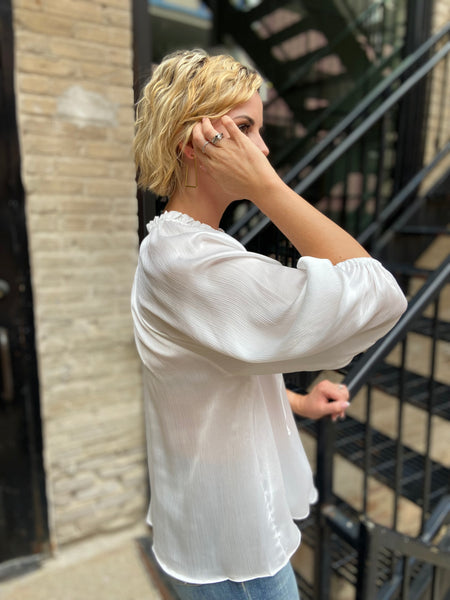 Side view of an ivory blouse