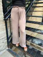 Embrace the whimsical charm of the Charlie Light Coco Pleated Pants! With a playful paper bag waist and a fashionable wide leg design, these pants are perfect for twirling into fall adventures. The adjustable drawstring ensures a comfortable fit, while the delightful stretchy fabric lets you lounge or dance with ease. 

- Playful pleated paper bag waist for a chic look 
- Comfortable stretchy fabric for all-day wear 
- Stylish wide leg silhouette for a flirty flair 
- Easy to care for: machine wash cold, li