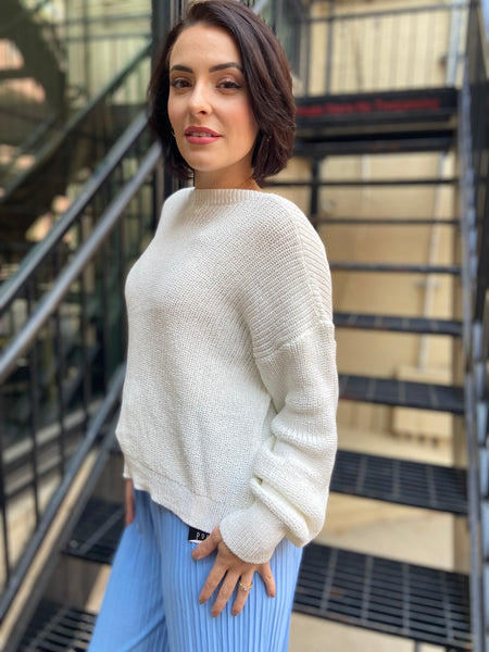 Side view of a white drop shoulder long sleeve sweater