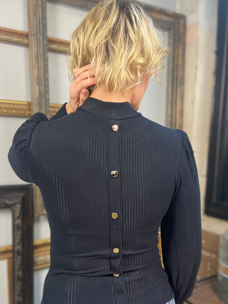 Back view of Black mock neck top from Blu Pepper with long sleeves and slight puff shoulder with decorative buttons down the back