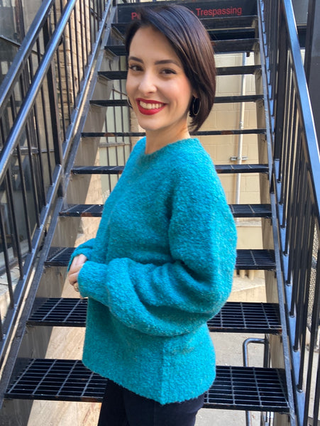 Side view of oversized turquoise sweater