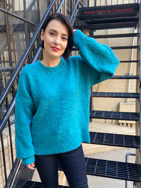 Full front view of an oversized turquoise sweater