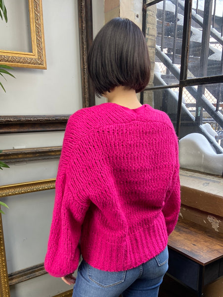 Back view of fuchsia cardigan sweater