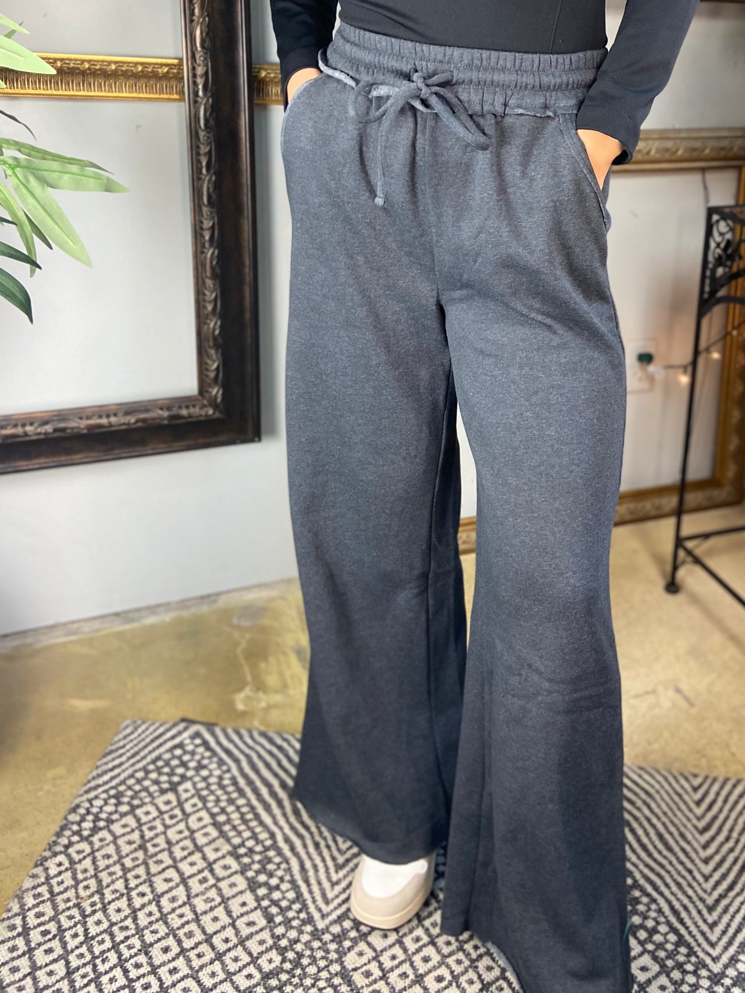 Charcoal colored fleece drawstring sweatpants with pockets and wide legs