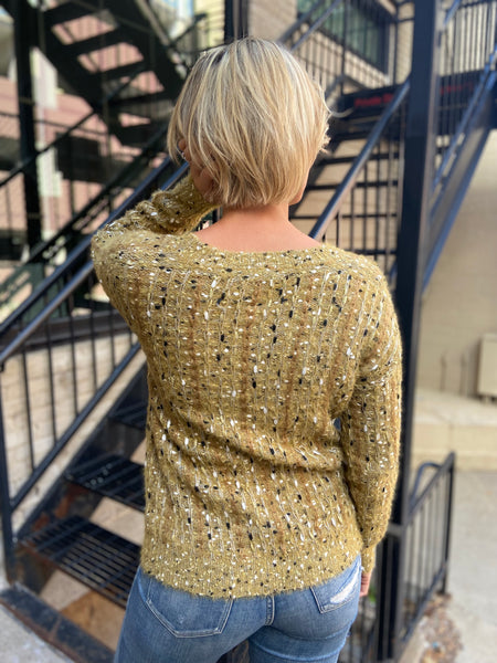 Back view of a mustard colored textured sweater