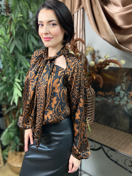 Brown and black abstract print long sleeved blouse with neck tie and shoulder cut out