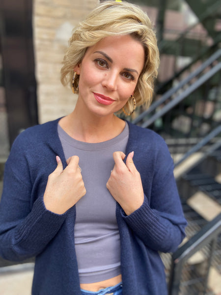 close up view of a navy blue cardigan sweater