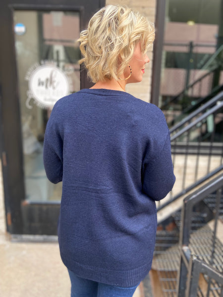 Back view of navy blue cardigan sweater