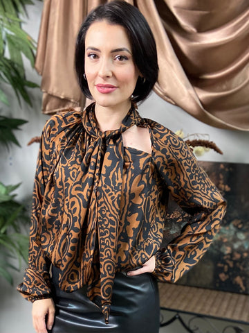 Brown and black abstract print long sleeved blouse with neck tie and shoulder cut out