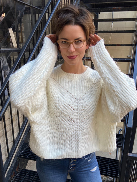 Full front view of a ivory sweater cropped to the waist