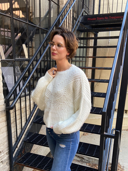 Ivory sweater paired with blue jeans