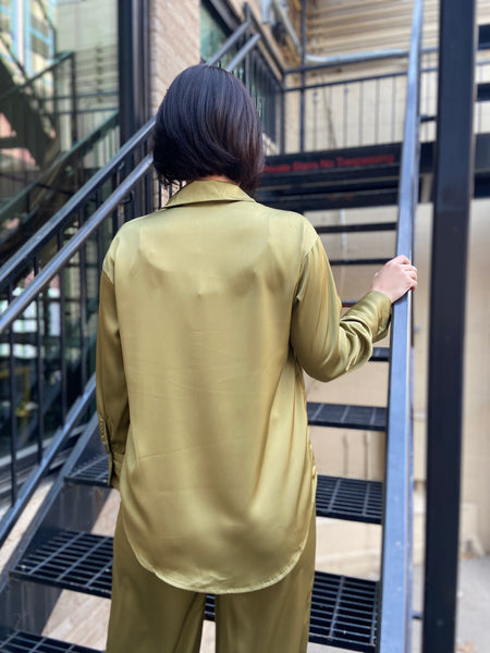 Back view of a satin olive colored button down top with matching pants