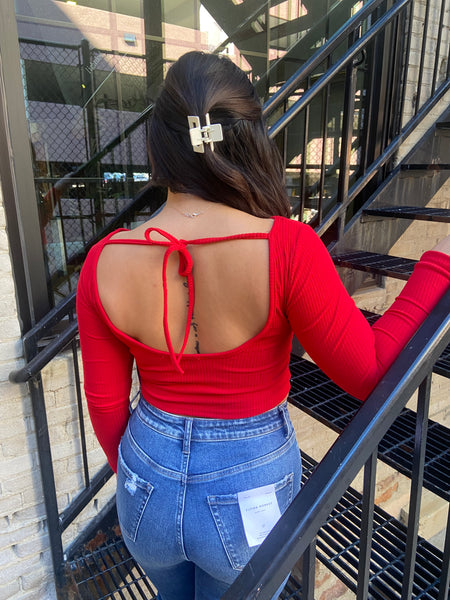 Back view of a Red  ribbed fitted cropped top with back tie detail