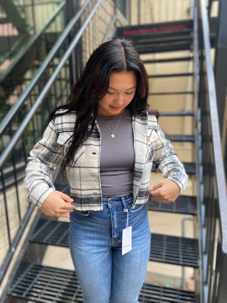 Gray & white plaid cropped shacket over a gray fitted tank paired with blue jeans