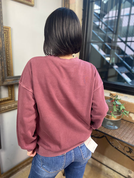 Back view of an eggplant colored fleece sweatshirt from Zenana