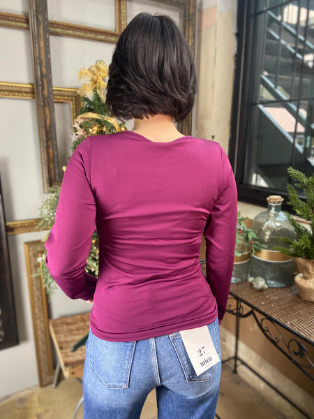 Back view of a Magenta colored fitted fleece lined v neck top