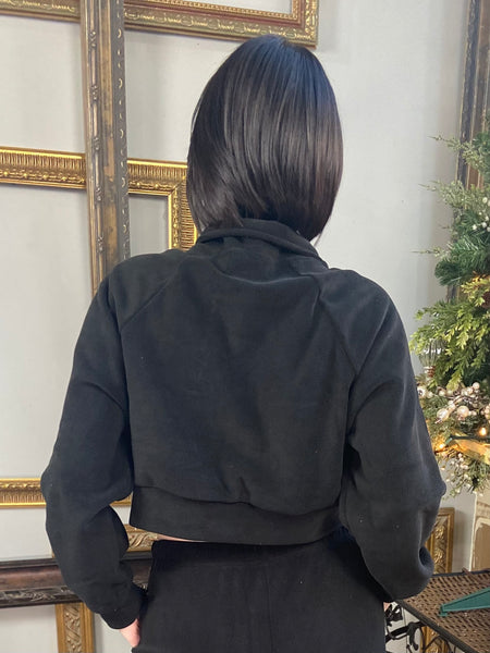 Back view of a black fleece track jacket with zipper closure from Love Poem