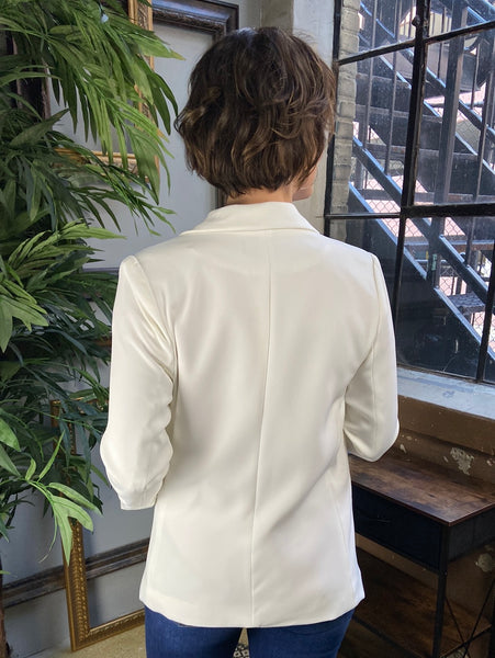 Back view of an ivory blazer