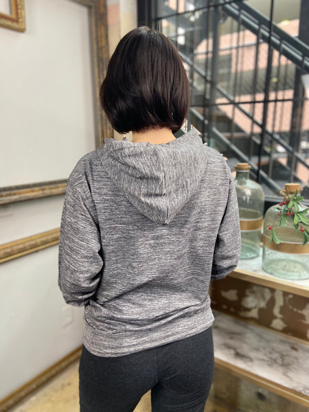 Back view of a marble Grey hooded drawstring sweatshirt with kangaroo pockets