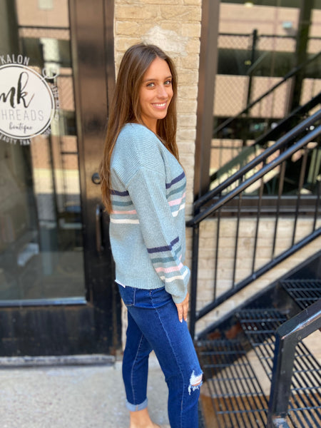 Side view of a Light blue striped v neck sweater