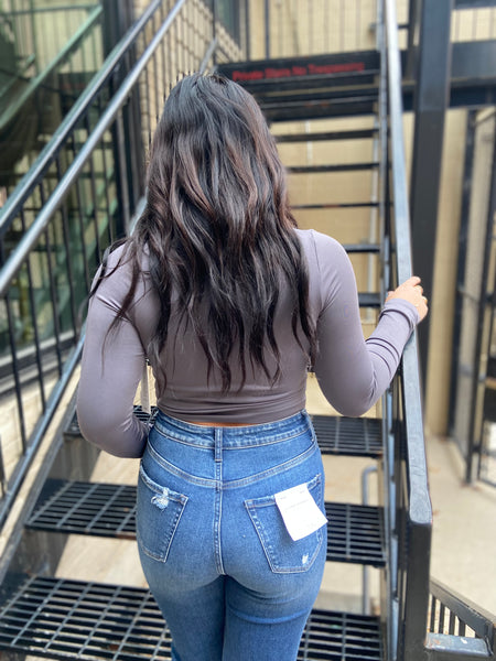 Back view of a Gray fitted long sleeved top