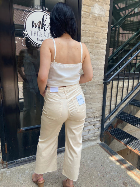 wide leg jeans cream jeans paired with lace top cropped solid beige jeans back view