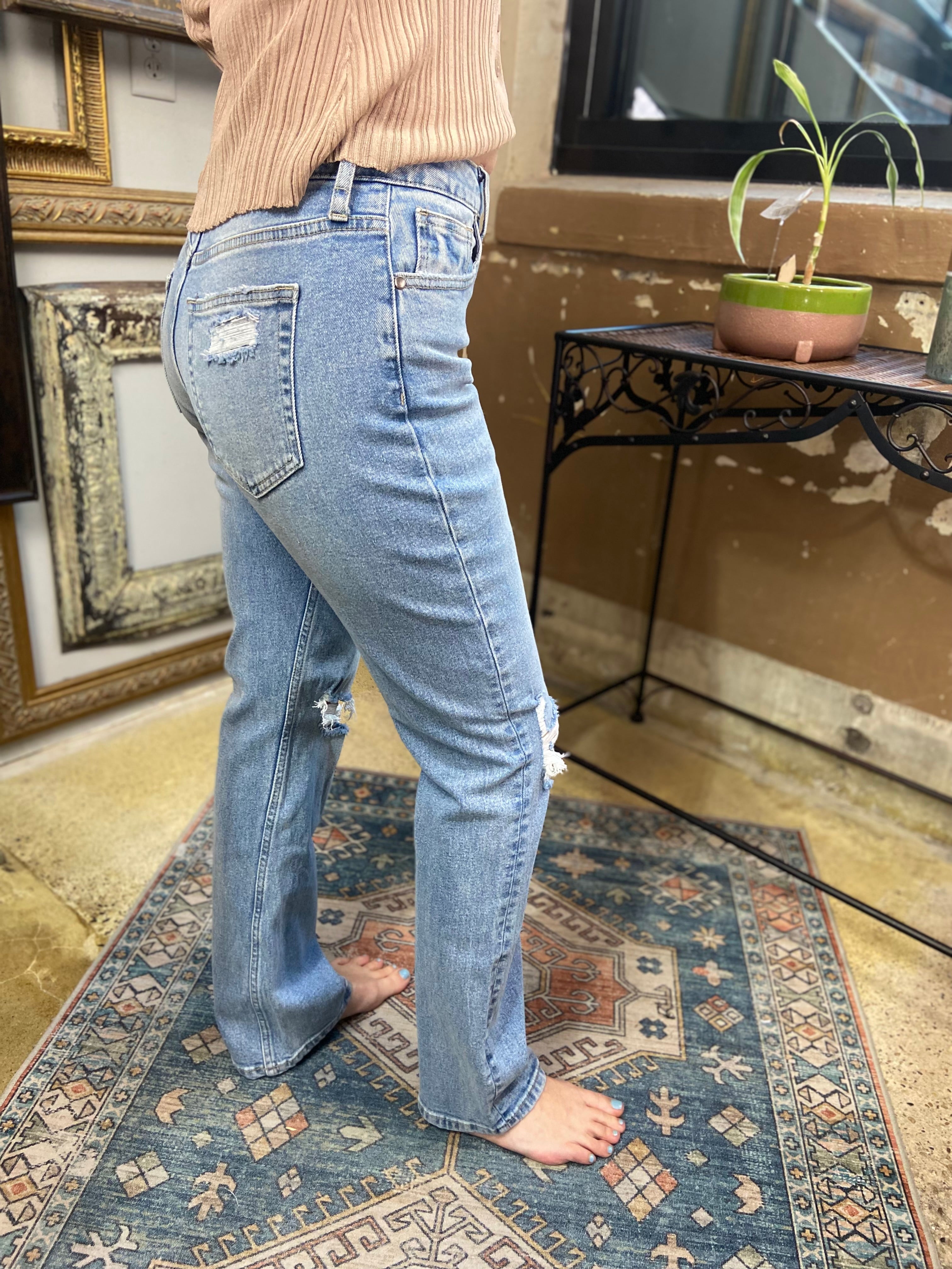 jelly jeans stright leg light wash knee rips high waisted cuffed bottom paired with taupe button up